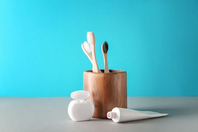 Set for dental hygiene on color background